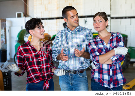 Agriculturists having conversation in facility Agriculturists having conversation in facility 94911302