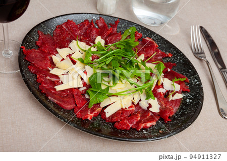 Raw beef meat, carpaccio, served on plate 94911327
