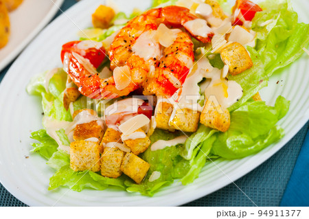 Caesar salad with grilled chicken on a white plate Caesar salad with grilled chicken on a white plate 94911377
