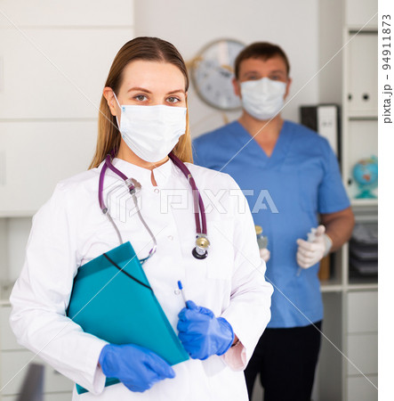 Female doctor in surgical mask in medical office Female doctor in surgical mask in medical office 94911873