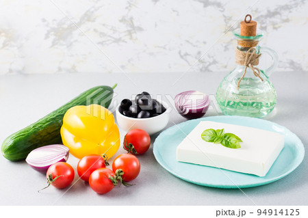Fresh ingredients for homemade Greek salad on the table. Domestic life Fresh ingredients for homemade Greek salad on the table. Domestic life 94914125