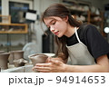 Beautiful woman making ceramic pottery on wheel, close-up. woman in freelance, business, hobby. 94914653