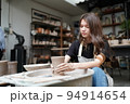 Beautiful woman making ceramic pottery on wheel, close-up. woman in freelance, business, hobby. 94914654