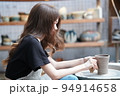 Beautiful woman making ceramic pottery on wheel, close-up. woman in freelance, business, hobby. 94914658