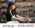 Beautiful woman making ceramic pottery on wheel, close-up. woman in freelance, business, hobby. 94914660