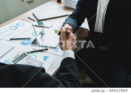 Businessman handshake for teamwork of business merger and acquisition,successful negotiate, two businessman shake hand with partner to celebration partnership and business deal concept. 94917894
