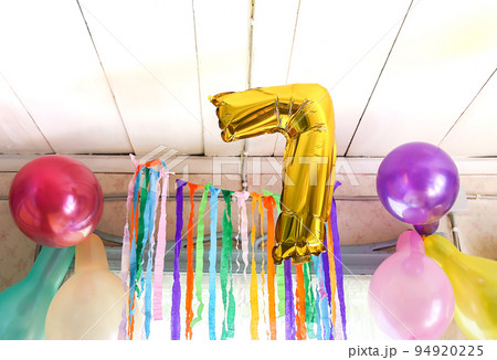 Gold balloon number 7. Child's birthdayparty decor in rural interior 94920225