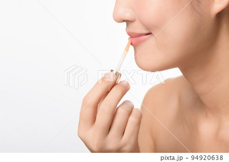 Portrait young asian woman looking mirror applying makeup lipstick at room 94920638