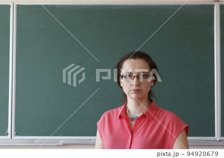 Woman in front of chalkboard 94920679