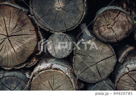 Aged balks. Wooden background. Rustic style. Old rough pile of tree bars different size with cracks and gaps copy space. 94920785