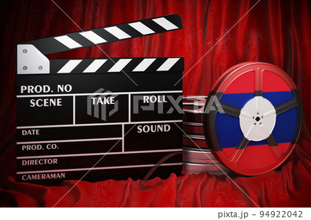 Laotian cinematography, film industry, cinema in Laos. Clapperboard with and film reels on the red fabric, 3D rendering 94922042
