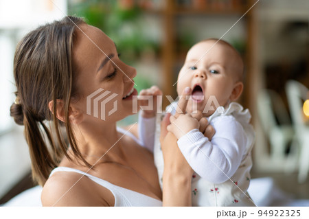 Mother and her baby girl playing and having fun. 94922325