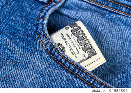Rolled up one hundred dollar bills in jeans pocket Rolled up one hundred dollar bills in jeans pocket 94922366