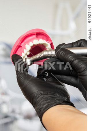 Dental instruments for teeth dental care in dentist's hands. Dental instruments for teeth dental care in dentist's hands. 94925445