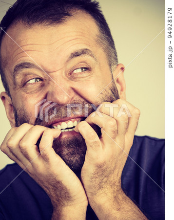 Man biting his nails Man biting his nails 94928179