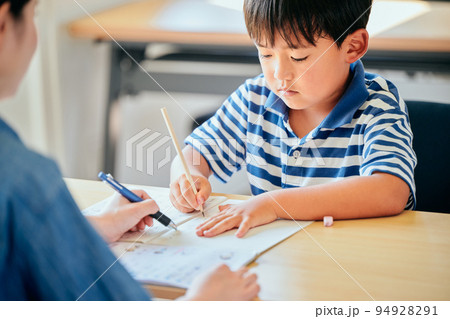 ノートに書き取りをする小学生の男の子 ノートに書き取りをする小学生の男の子 94928291