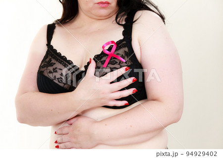 Woman chest in bra, pink cancer ribbon 94929402