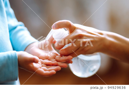 Hands with sanitizer gel. Mother and child using sanitize soap for hand coronavirus protection. Hands with sanitizer gel. Mother and child using sanitize soap for hand coronavirus protection. 94929636