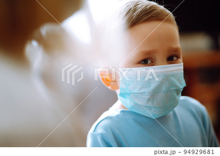 Little boy wearing a protective sterile medical mask. Child, wearing face mask. Covid-19. 94929681