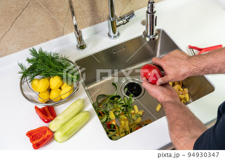 Preparing fresh vegetable salad in modern beautiful kitchen 94930347