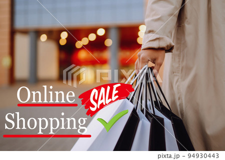 Young woman with shopping bags near mall. Spring Style. Consumerism, purchases, shopping, lifestyle. Young woman with shopping bags near mall. Spring Style. Consumerism, purchases, shopping, lifestyle. 94930443