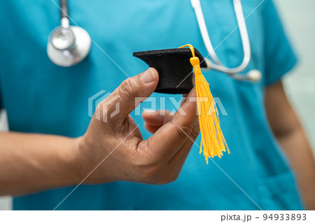 Asian doctor study learn with graduation gap hat in hospital ward, clever bright genius education medicine concept. Asian doctor study learn with graduation gap hat in hospital ward, clever bright genius education medicine concept. 94933893
