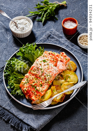 salmon with potato and tarragon sour cream sauce 94934231