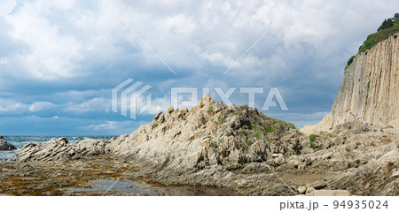ocean shore with rocks of columnar basalt, Cape Stolbchaty on Kunashir Island ocean shore with rocks of columnar basalt, Cape Stolbchaty on Kunashir Island 94935024