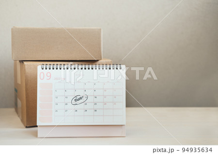Same Day delivery Ship From Store. Faster Delivery. Many Cardboard boxes and calendar with the date today ready for delivery 94935634
