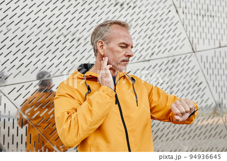 Mature Man Checking Pulse Rate After Workout 94936645