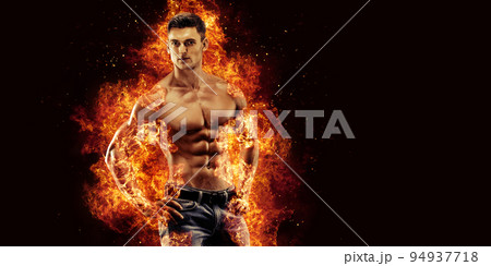 Bodybuilder posing on the fire flames background Bodybuilder posing on the fire flames background 94937718
