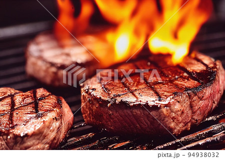 Grilled mignon steak cooking on flame. Steaming beef tenderloin over blazing fire. Red meat filet mignon on grill grid. Closeup selective focus, shallow depth of field Grilled mignon steak cooking on flame. Steaming beef tenderloin over blazing fire. Red meat filet mignon on grill grid. Closeup selective focus, shallow depth of field 94938032