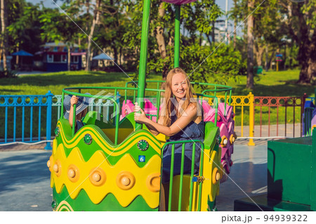 Mom and son having fun at an amusement park Mom and son having fun at an amusement park 94939322