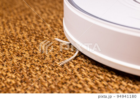 Vacuum robot on the straw carpet Vacuum robot on the straw carpet 94941180
