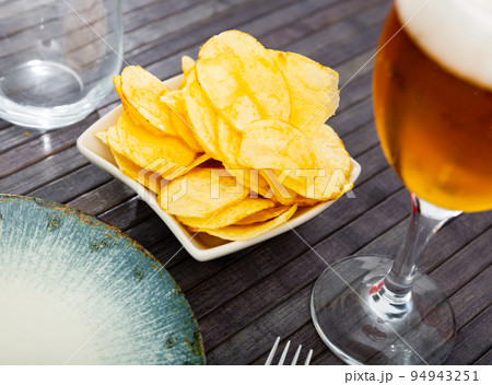 Appetizing chips with a glass of beer Appetizing chips with a glass of beer 94943251