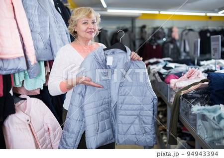 female consumer choosing windbreaker jackets female consumer choosing windbreaker jackets 94943394
