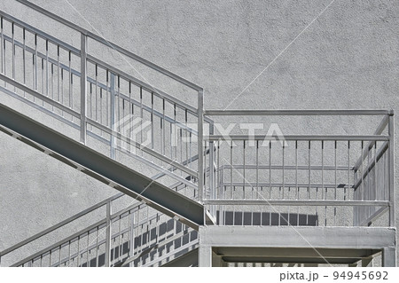 Gray metallic staircase landing and wall in warm gray moonlight  94945692