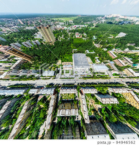 Aerial city view with crossroads and roads, houses, buildings, parks and parking lots. Sunny summer panoramic image 94946562