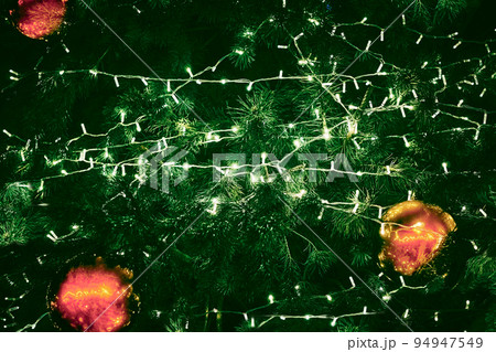 Background with New Year toys, green branches and lights of a christmas tree 94947549