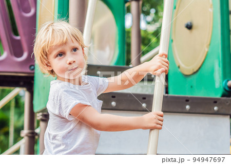 Funny cute happy baby playing on the playground. The emotion of happiness, fun, joy 94947697