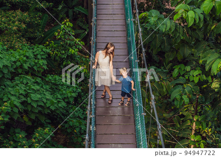 Mother and son at the Suspension bridge in Kuala Lumpur, Malaysia Mother and son at the Suspension bridge in Kuala Lumpur, Malaysia 94947722