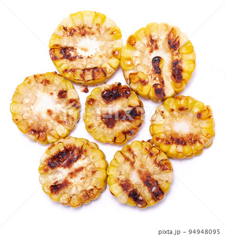 Grilled Slices of corn cobs with stripes from a grill isolated on white background Grilled Slices of corn cobs with stripes from a grill isolated on white background 94948095