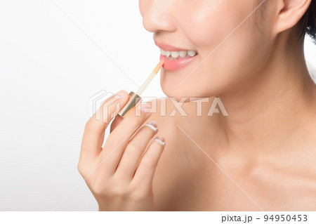 Portrait young asian woman looking mirror applying makeup lipstick at room 94950453