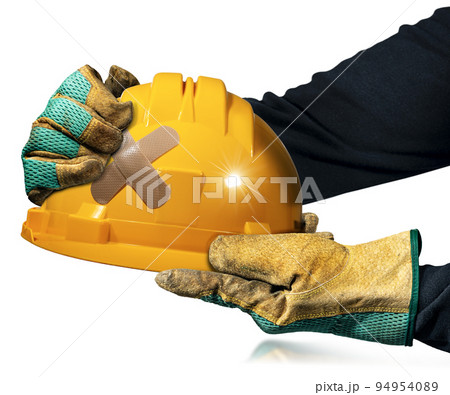 Gloved Hands Holding an Orange Safety Helmet with Cross Band Aid 94954089