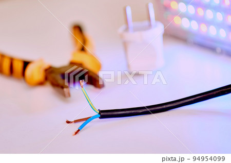 Black three-core electric cable, metalwork pliers and LED lamp 94954099