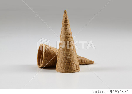Two empty, medium wafer cones for ice cream isolated on white. Concept of food, treats. Mockup, template for your advertising and design. Close up Two empty, medium wafer cones for ice cream isolated on white. Concept of food, treats. Mockup, template for your advertising and design. Close up 94954374