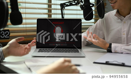 Image of radio host using microphone and laptop to recording podcast in home studio. Radio, podcasts and technology concept Image of radio host using microphone and laptop to recording podcast in home studio. Radio, podcasts and technology concept 94955658