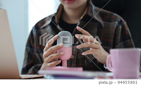 Image of radio host using microphone and laptop to recording podcast in home studio. Radio, podcasts and technology concept 94955801