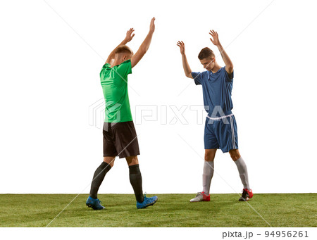 Salutation. Rival soccer players wearing blue and green football kits greeting each other before game isolated over white background. 94956261