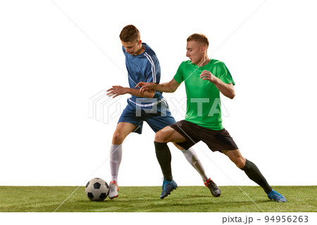 Soccer football players tackling for the ball on grass flooring over white background. Concept of sport, action, competition, football match 94956263